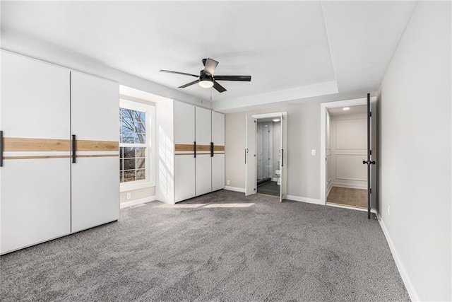 unfurnished bedroom featuring baseboards, carpet floors, and ceiling fan