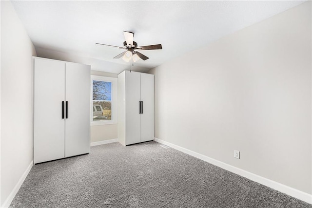 unfurnished bedroom with baseboards, light colored carpet, and ceiling fan