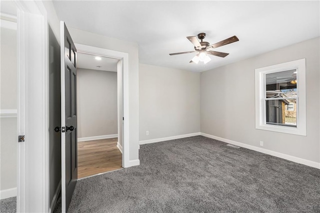 unfurnished bedroom featuring ceiling fan, baseboards, and carpet