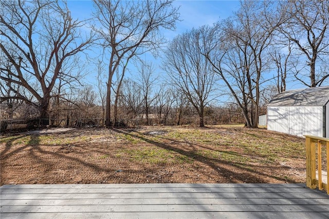 deck featuring an outbuilding, a storage unit, and fence