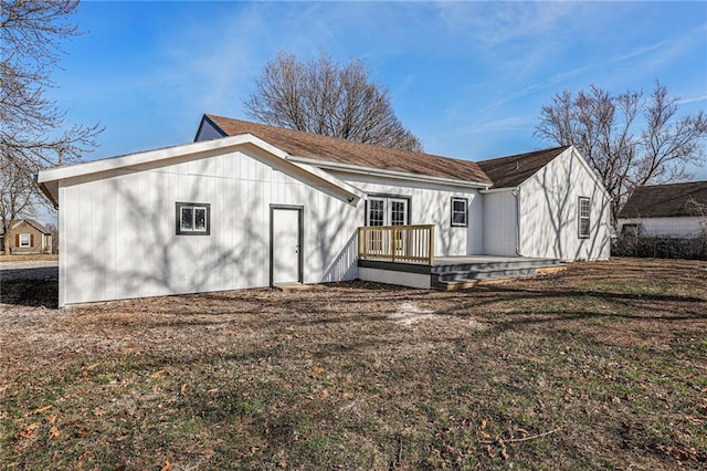 back of house with a deck, a yard, and french doors