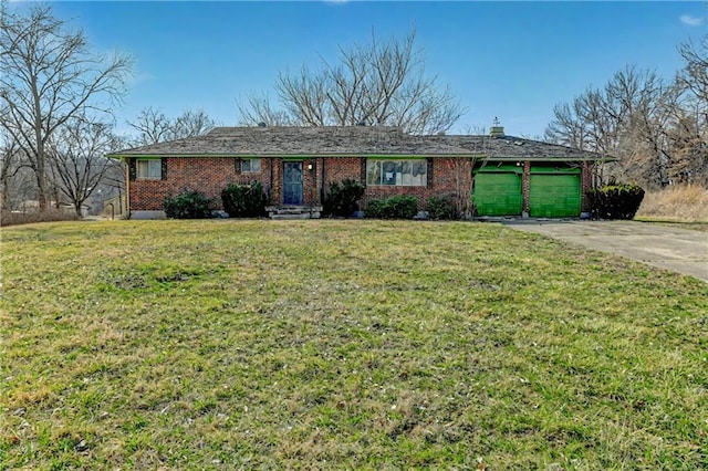 ranch-style home with brick siding, an attached garage, concrete driveway, and a front yard