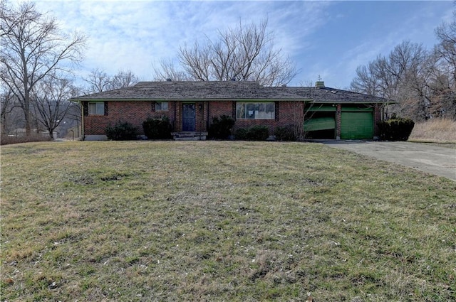 single story home featuring driveway, a front lawn, an attached garage, brick siding, and a chimney