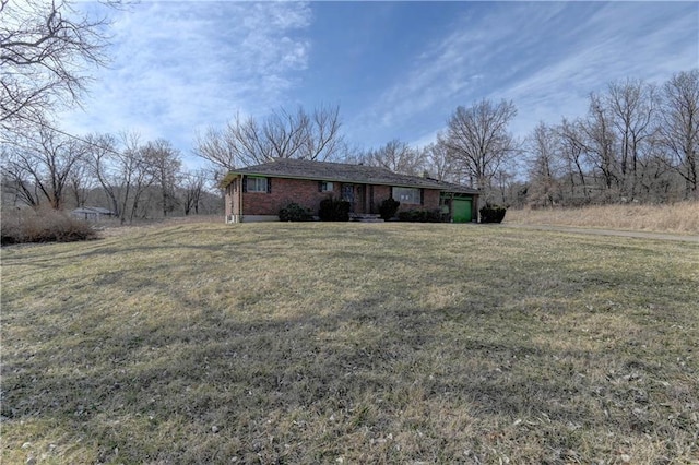 view of front of house featuring a front yard and brick siding