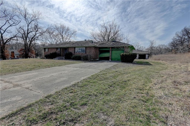 ranch-style home with concrete driveway, a front yard, and a garage