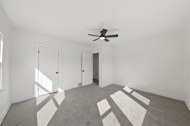 interior space featuring baseboards, carpet floors, and ceiling fan