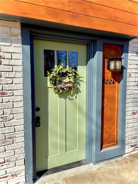 property entrance featuring brick siding