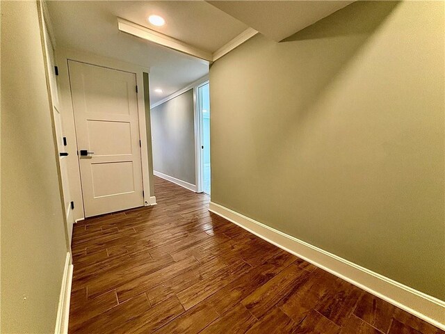 corridor with recessed lighting, baseboards, and wood finished floors