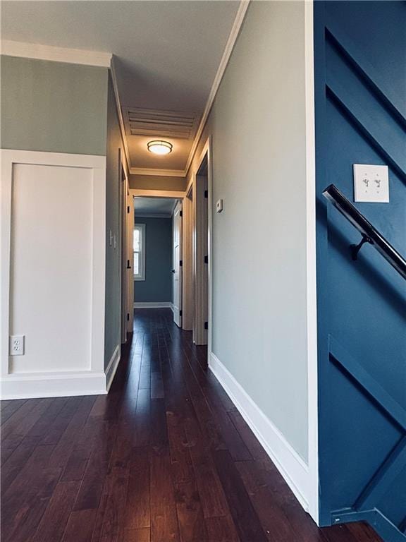 hall with visible vents, crown molding, baseboards, and wood-type flooring