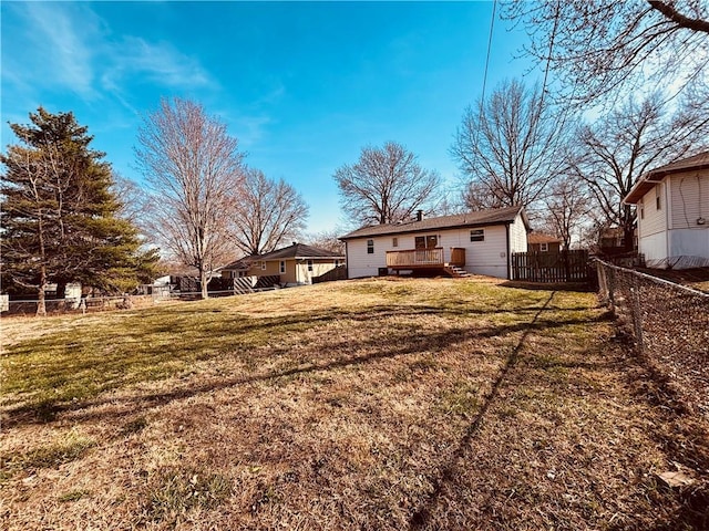 view of yard with a fenced backyard and a deck