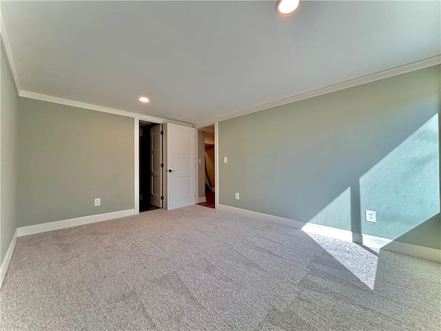 spare room with recessed lighting, carpet flooring, baseboards, and crown molding