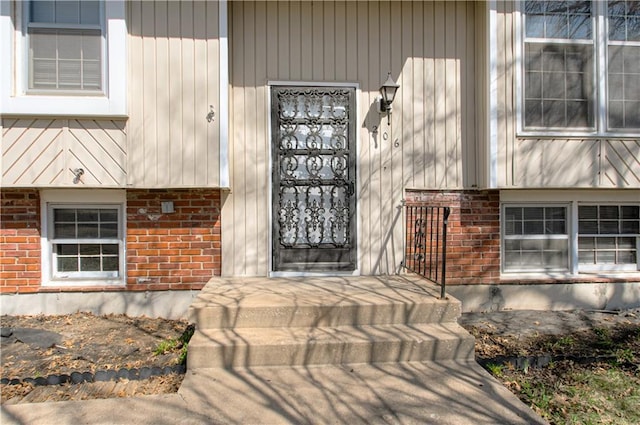 doorway to property with brick siding