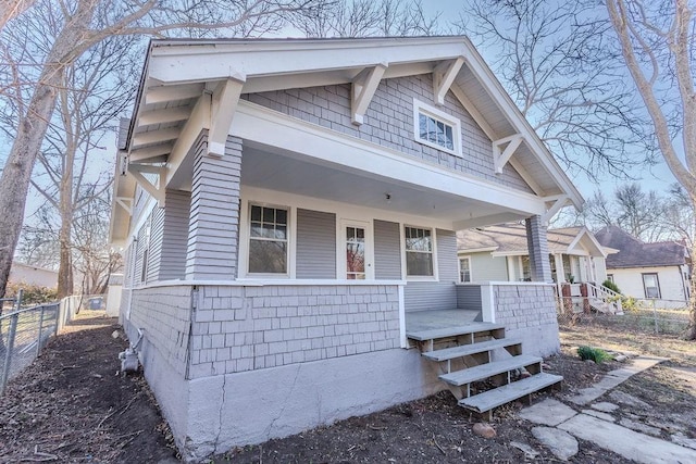 view of front of home featuring fence and covered porch