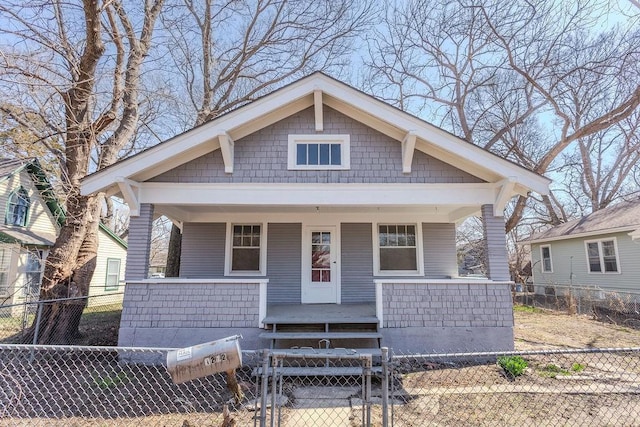 bungalow featuring a porch, a gate, and a fenced front yard