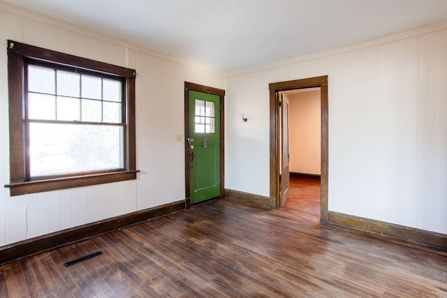 interior space with wood finished floors, visible vents, and baseboards