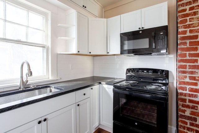 kitchen featuring tasteful backsplash, plenty of natural light, white cabinetry, and black appliances