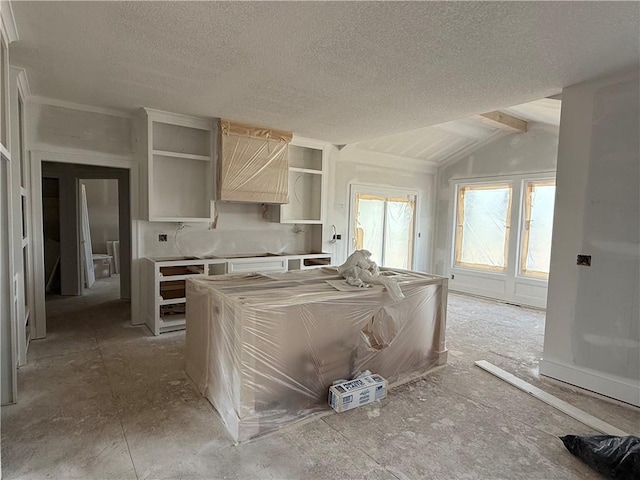 kitchen with open shelves, lofted ceiling, and a textured ceiling