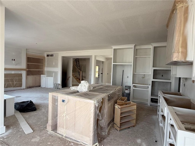 interior space with a textured ceiling