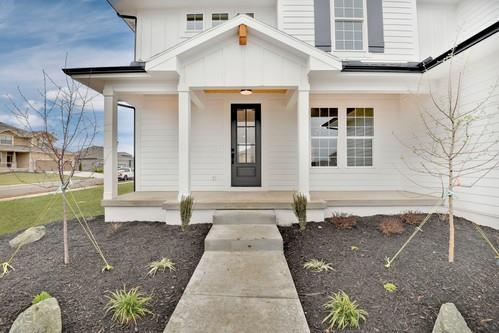 view of exterior entry featuring covered porch