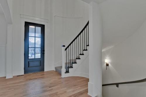 entrance foyer with stairway and wood finished floors