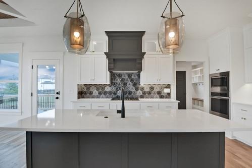 kitchen featuring tasteful backsplash, light countertops, appliances with stainless steel finishes, and white cabinets