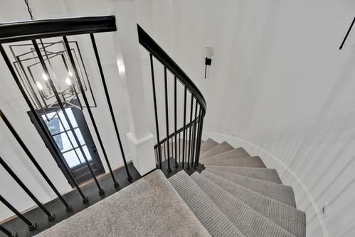 stairs with an inviting chandelier