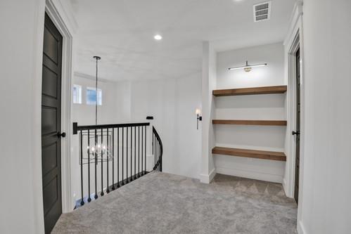 hallway with recessed lighting, carpet flooring, visible vents, and an upstairs landing