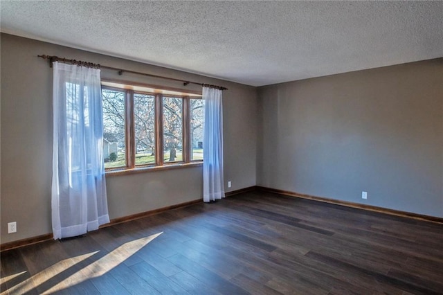 unfurnished room with baseboards and dark wood-style flooring