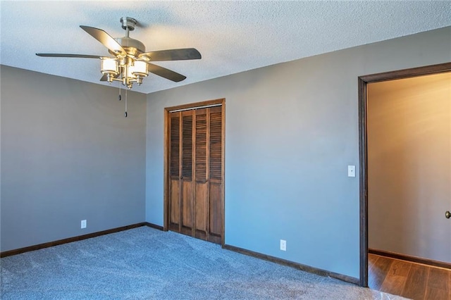 unfurnished bedroom with a closet, a textured ceiling, baseboards, and a ceiling fan