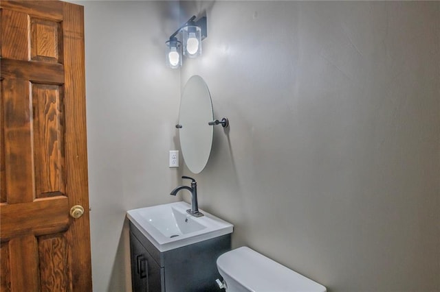 bathroom featuring toilet and vanity