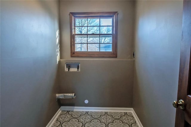 washroom with tile patterned flooring, laundry area, washer hookup, and baseboards