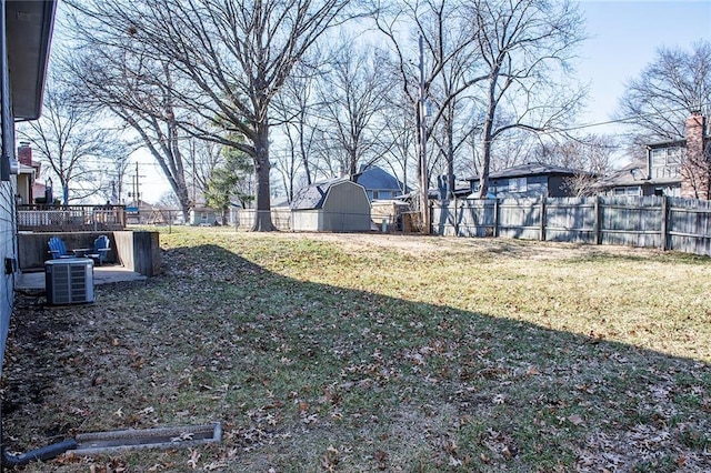 view of yard with an outbuilding, cooling unit, and a fenced backyard