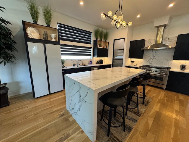 kitchen featuring island range hood, a center island, high end stainless steel range, and dark cabinets