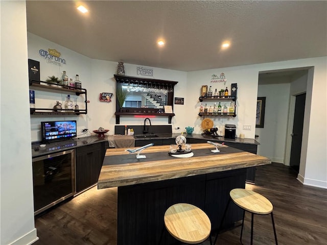 bar featuring dark wood-style floors, recessed lighting, wine cooler, indoor wet bar, and baseboards