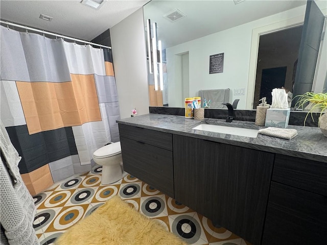 bathroom featuring vanity, a shower with shower curtain, visible vents, tile patterned flooring, and toilet