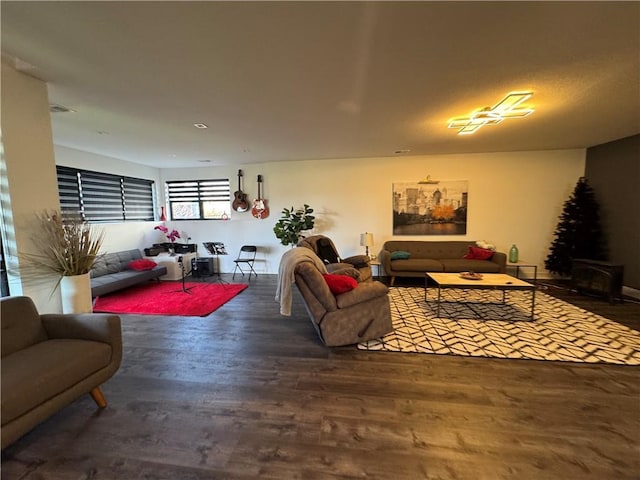 living room with wood finished floors and a wood stove