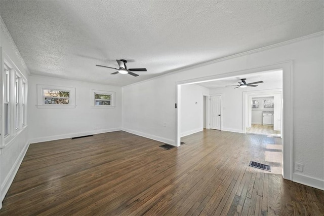 spare room featuring visible vents, ceiling fan, and dark wood finished floors