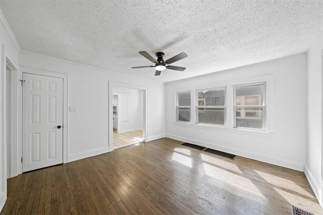 unfurnished bedroom featuring visible vents, a textured ceiling, baseboards, and hardwood / wood-style flooring