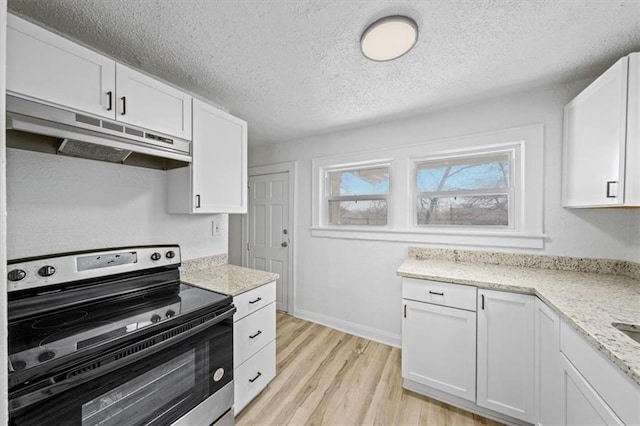 kitchen with under cabinet range hood, white cabinetry, and electric stove