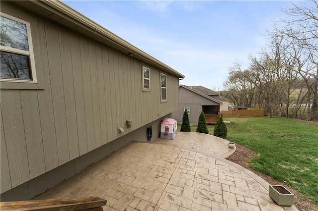view of home's exterior featuring a patio and a lawn