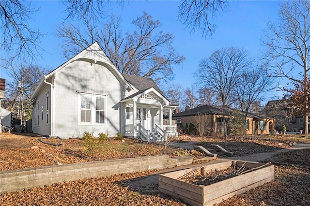 rear view of house featuring a vegetable garden