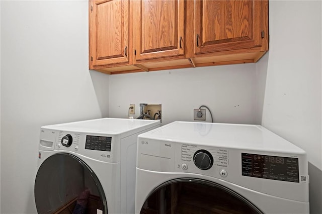 washroom with cabinet space and independent washer and dryer