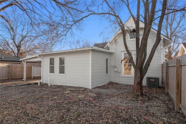 back of property featuring central air condition unit and a fenced backyard