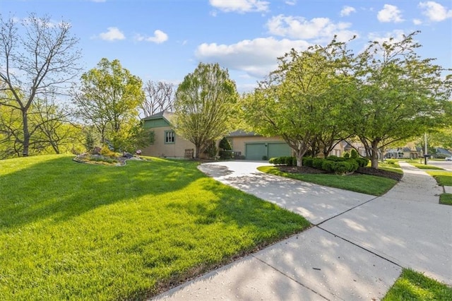 view of front of property featuring a garage, stucco siding, driveway, and a front lawn