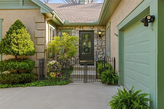 property entrance with a garage, aphalt driveway, stone siding, stucco siding, and a shingled roof