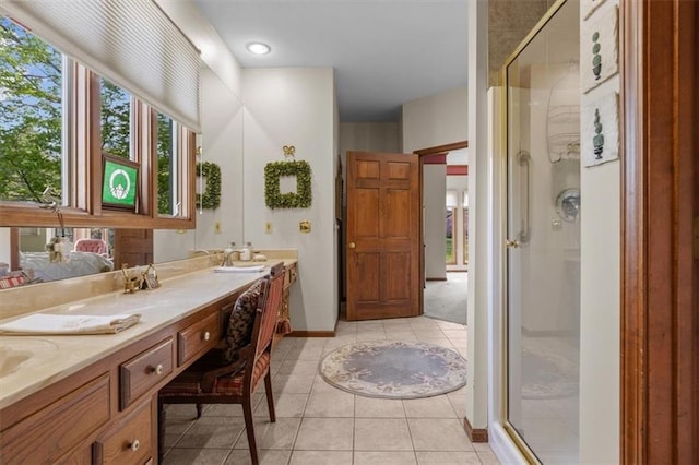 bathroom featuring double vanity, tile patterned flooring, and a shower stall