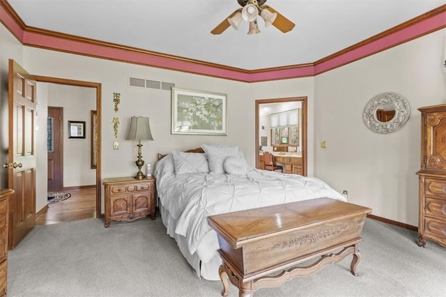 bedroom with ceiling fan, light carpet, baseboards, ensuite bathroom, and visible vents