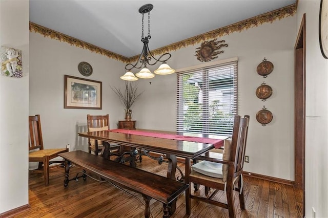 dining space featuring baseboards and wood-type flooring