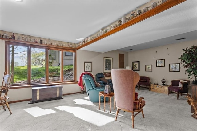 interior space with baseboards, carpet flooring, and visible vents