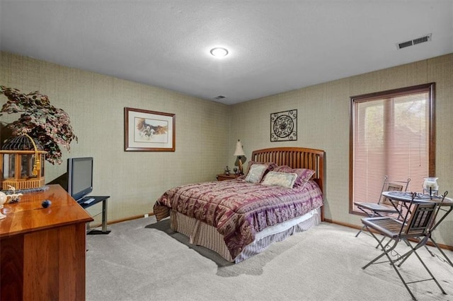 carpeted bedroom with visible vents and baseboards